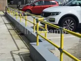 yellow powder coated DDA disability handrails outside of cafe in Wales.