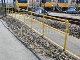 Yellow powder coated safety handrails by train station