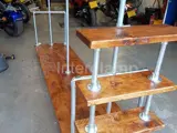 Industrial wooden clothing rail and shelves using Interclamp clothing rail from steel tube and key clamp fittings 