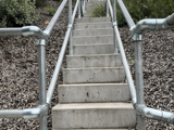 An Interclamp key clamp handrail installed either side of a motorway maintenance stairway.