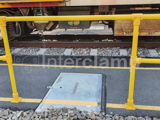 yellow powder coated safety handrails on train platform in Queensland, Australia