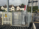 Interclamp key clamp fittings and mesh panels used to construct a custom barrier around a level crossing barrier